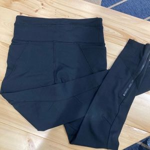 Running leggings with lots of pockets and ankle zips.